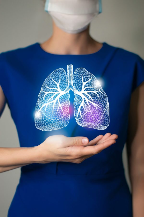 Woman in blue clothes holding virtual Lungs in hand. Handrawn human organ, detox and healthcare, healthcare hospital service concept stock photo